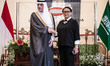 Minister of Foreign Affairs of Saudi Arabia, Adel al-Jubeir (L) shakes hands with Indonesi...