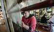 Women weave the silk carpet at the Samarkand-Bukhara Silk Carpets workshop, Samarkand, Uzb...