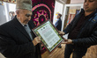 Hoji Muhhamad Ewaz Badghisi, founder of Samarkand-Bukhara Silk Carpets workshop, holds hon...