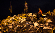 Two anti-government protesters stand on a barricade in Kiev, on February 15, 2014. Protest...