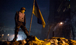 An anti-government protester stands on a barricade in Kiev, on February 15, 2014. Proteste...
