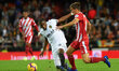 Geoffrey Kondobia of Valencia CF and Pere Pons of Girona FC during the La Liga match betwe...