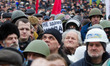 People hold the plakards which say "We'll not give you of city hall" during a new, mass de...