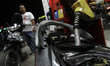 Workers fill the fuel rider in the middle of the queue when the President of Indonesia, Jo...