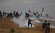Palestinians protesters carry national flags as they gather during a protest, east of Gaza...