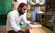 Multan, Pakistan, 4 October 2018. A young Sufismist reads the Koran inside Bahauddin Zakar...