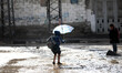 Children returning from school who walks the street during rain 'has hit Gaza very low in...