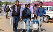 Election officials leaves after collecting their Electronic Voting Machine (EVM) from an E...