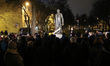 People protesting against monument and square named priest Henryk Jankowski name are seen...