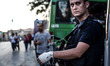 An officer with an injured hand guards the Tarlabasi police station near Taksim Square. Po...