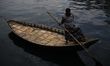 A boat man waits for passengers at Sadarghat ferry terminal in Dhaka, Bangladesh on Decemb...