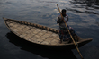 A boat man waits for passengers at Sadarghat ferry terminal in Dhaka, Bangladesh on Decemb...