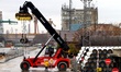 Workers arrange pipes delivered for construction of the South Stream gas pipeline and load...