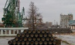 Workers arrange pipes delivered for construction of the South Stream gas pipeline and load...
