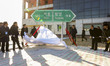 Officials from South and North Korea unveil a road sign during the ceremony for a project...