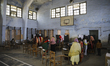 A Bangladeshi woman voter has her biometric card cross-checked with her fingerprint upon a...