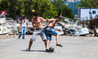 ISTANBUL, TURKEY--Men play soccer while fights rage nearby between police and protesters o...