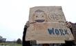 Furloughed federal workers, joined by elected officials, hold up sings to protest the fede...