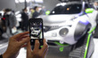 A visitor takes pictures of a Nissan Juke Personalization Adventure Concept at the Nissan...