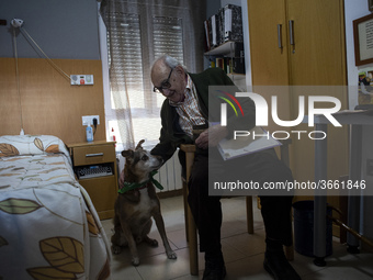An old man plays with Miko in his room at the Residencia San Cipriano in Soto de la Marina, Cantabria, Spain, on 16 January  in one of the t...