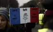 a person holding a sign  during an anti-government demonstration called by the Yellow Vest...