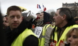 a group of people standing in front of a crowd  during an anti-government demonstration ca...