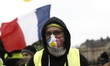 a man wearing a hat  during an anti-government demonstration called by the Yellow Vest mov...