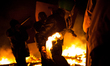 Anti-government protesters clash with the police during their storm of the Independence Sq...