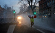A Yellow vest with a French flag runs away from police water cannon. For the Act X (Act 10...