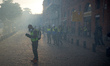 A Yellow Vest protester writes a SMS amid clouds of tear gas. For the Act X (Act 10) of th...