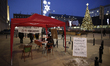 A half dozen people are seen gathered in front of the state broadcaster TVP Info headquart...