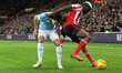 . Benji Kimpioka of Sunderland battles for possession with Colin Rsler of Manchester City...