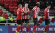 . Sunderland's Dylan McGeouch, Benji Kimpioka and Bryan Oviedo congratulate Duncan Watmore...