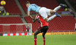 . Taylor Harwood-Bellis of Manchester City climbs over Benji Kimpioka to head the ball awa...