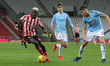 . Benji Kimpioka of Sunderland takes on Taylor Harwood-Bellis during the Checkatrade Troph...