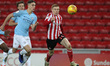 . Taylor Harwood-Bellis of Manchester City in action with Duncan Watmore of Sunderland dur...