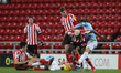 . Benji Kimpioka of Sunderland battles with Colin Rsler of Manchester City  during the Che...