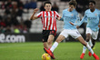 . Luke O'Nien of Sunderland battles with Iker Pozo of Manchester City  during the Checkatr...