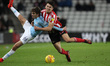 . Luke O'Nien of Sunderland battles with Iker Pozo of Manchester City  during the Checkatr...
