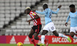 Benji Kimpioka of Sunderland and Richard Dionkou of Manchester City in action during the C...