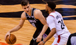  Bogdan Bogdanovic #8 of the Sacramento Kings with the ball against Norman Powell #24 of t...