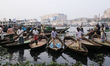 Boatmen wait for passengers on the bank of the Buriganga River in Dhaka, Bangladesh on Jan...
