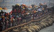 Indian holy saints move on a pantoon tank bridge to take a holy dip at sangam , - the conf...