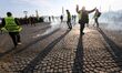 French yellow vests (Gilets jaunes) protesters walk in tear gas during clashes with French...