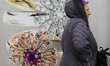 A woman walks past a jewelry shop window in Kyiv, Ukraine, February 5,2019 