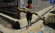 A Rohingya refugee child carries bamboo pieces in the Balukhali refugee camp in Ukhia, Cox...