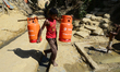 A Rohingya refugee child carries gas cylinder in the Balukhali refugee camp in Ukhia, Cox'...