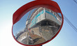 An Indian paramilitary soldier is reflected in the convex mirror installed near a check po...