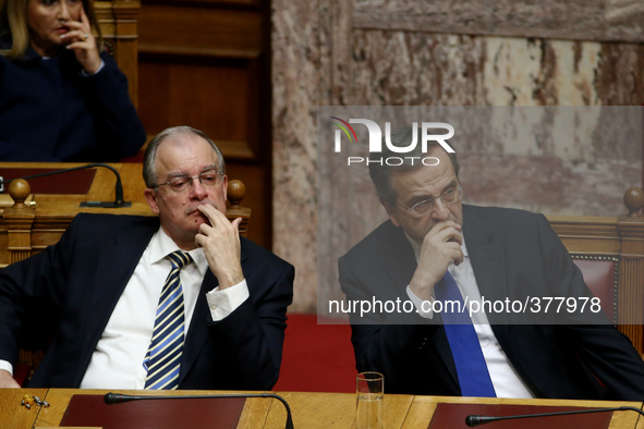 Greek Prime Minister Antonis Samaras (R) with Culture Minister Konstantinos Tasoulas at the plenum of the Greek Parliament during the first...