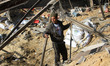 A Palestinian man inspect the damage in a chicken farm after Israeli air strike last night...